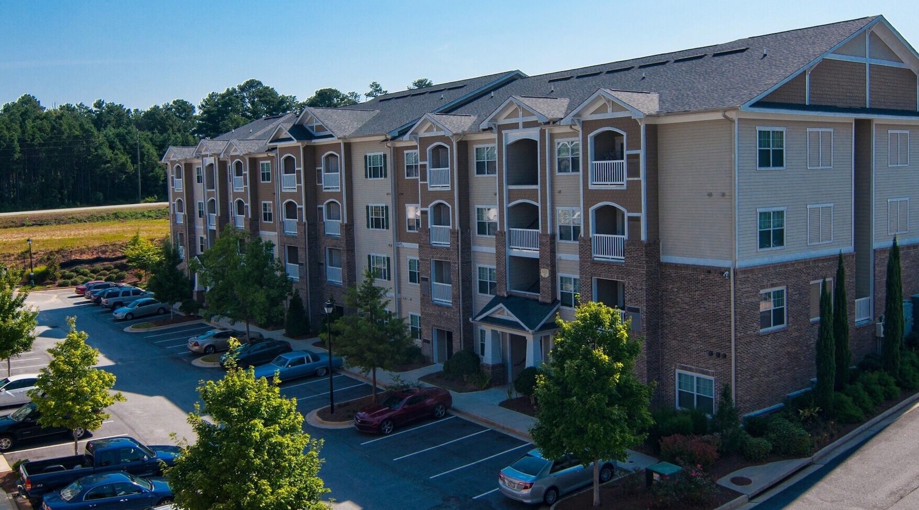 a large building with a parking lot and windows
