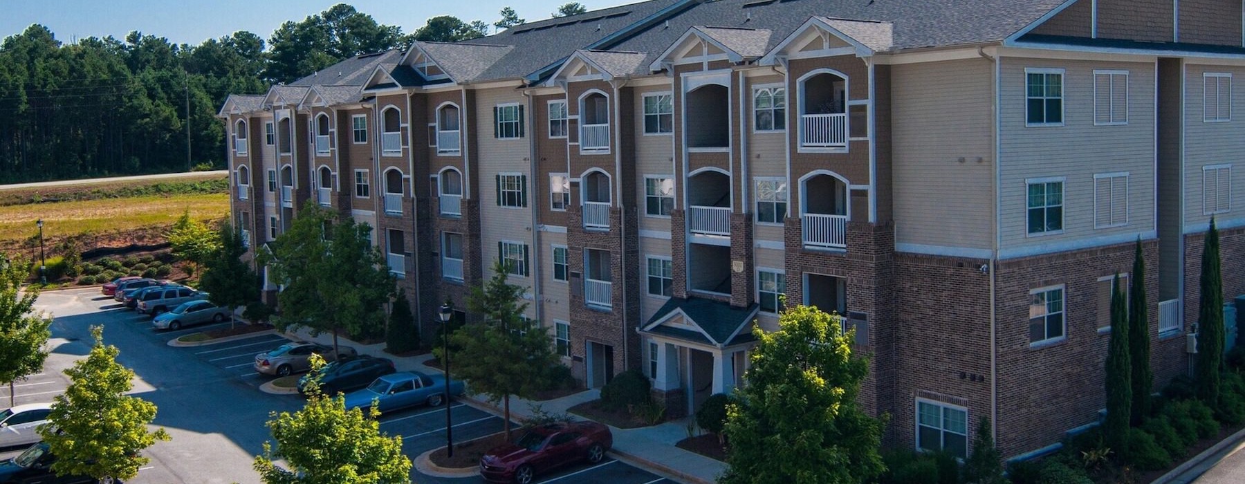a large building with a parking lot and windows