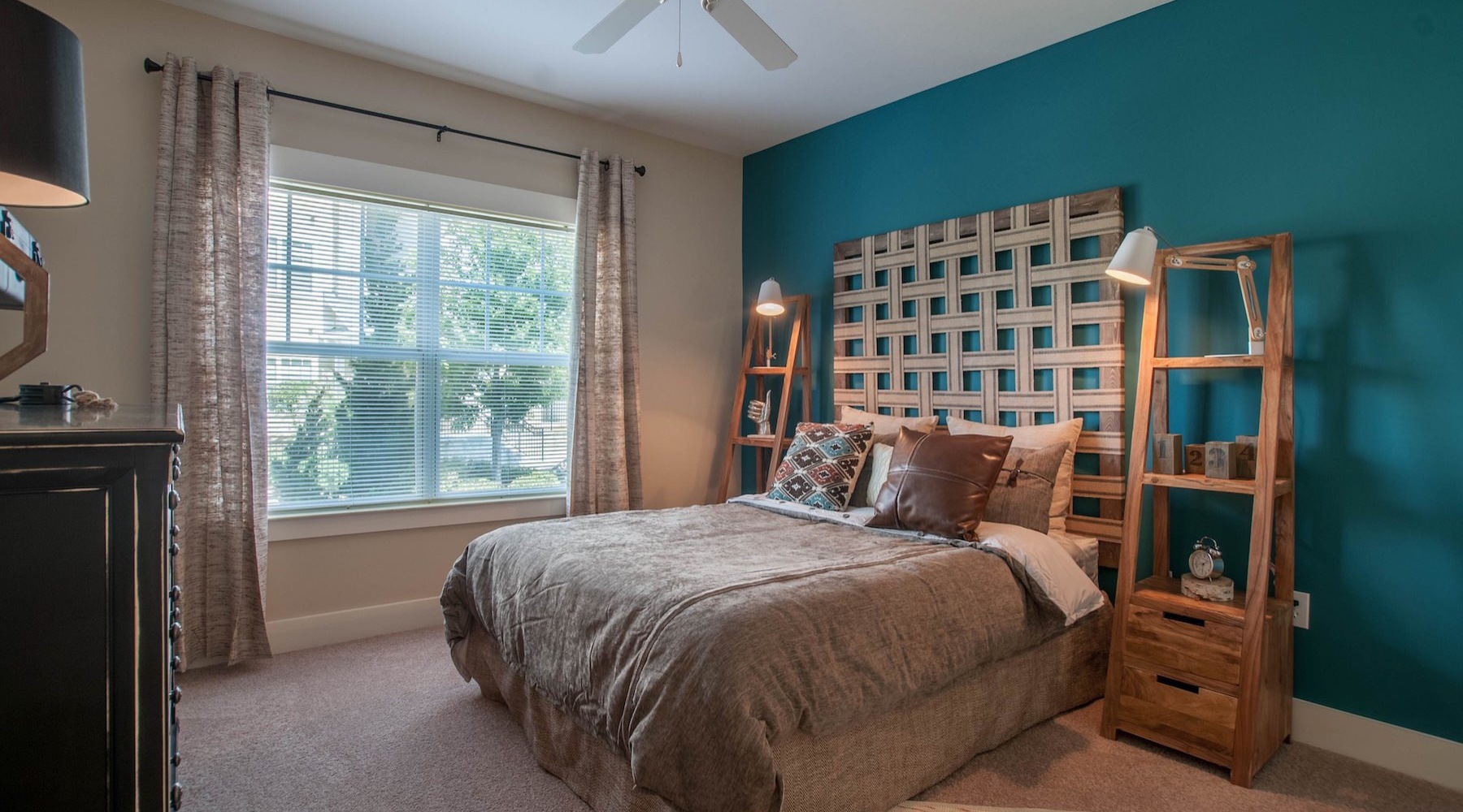 a bedroom with a bed and a large window