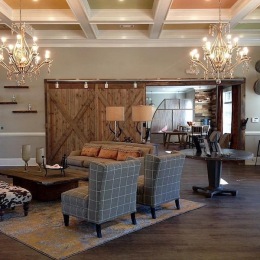 a clubroom with a couch, tables and chairs