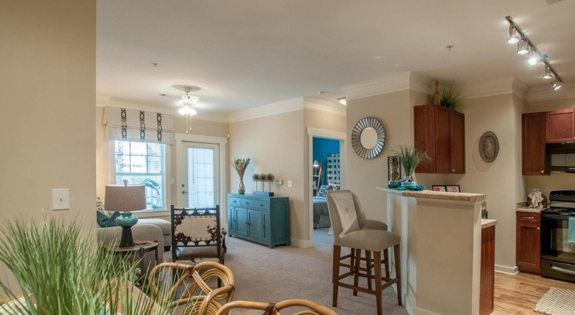 a living room with a dining table and chairs