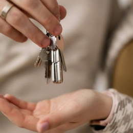 a person giving keys to another person