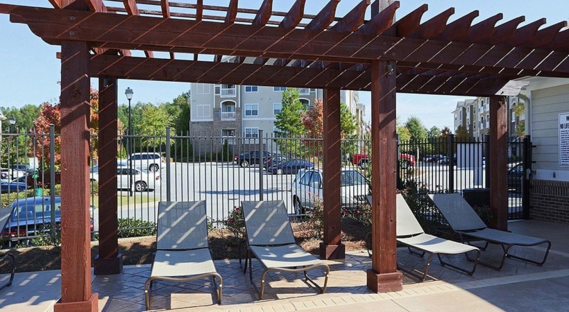 a group of benches sit under a covered area