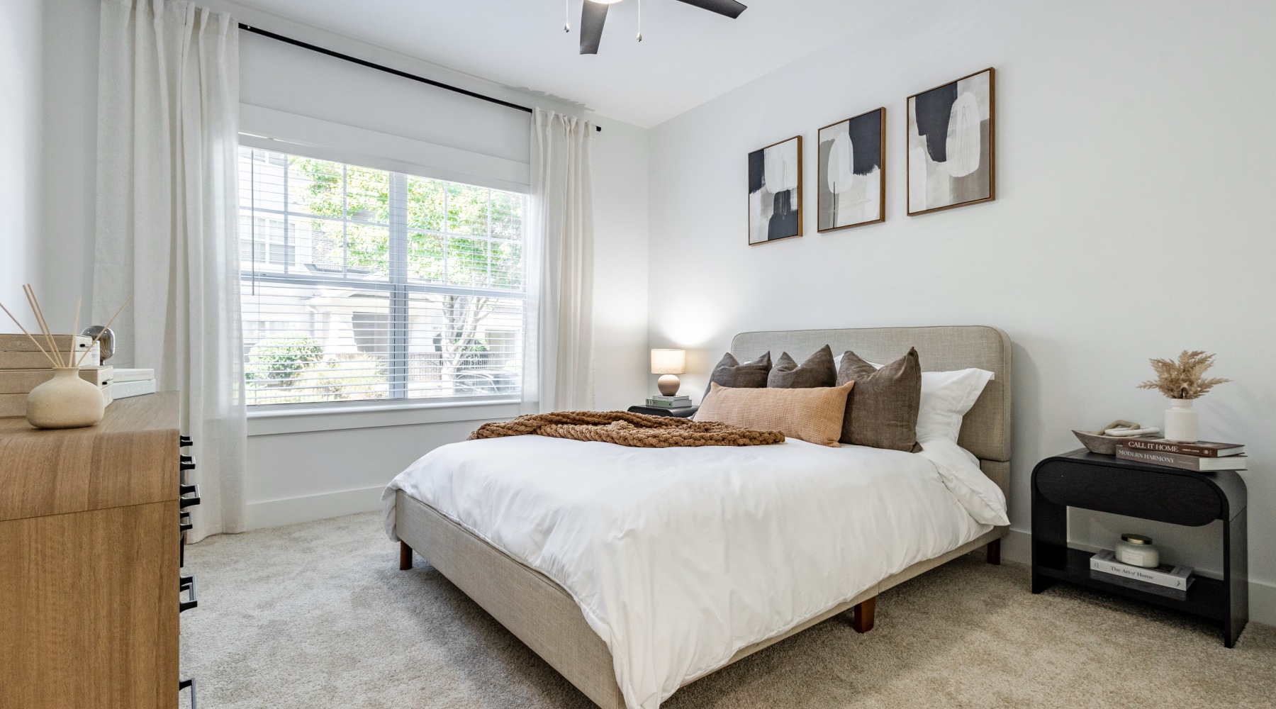 a bedroom with a bed and a large window