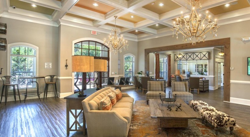a large living room with a chandelier and a large dining room